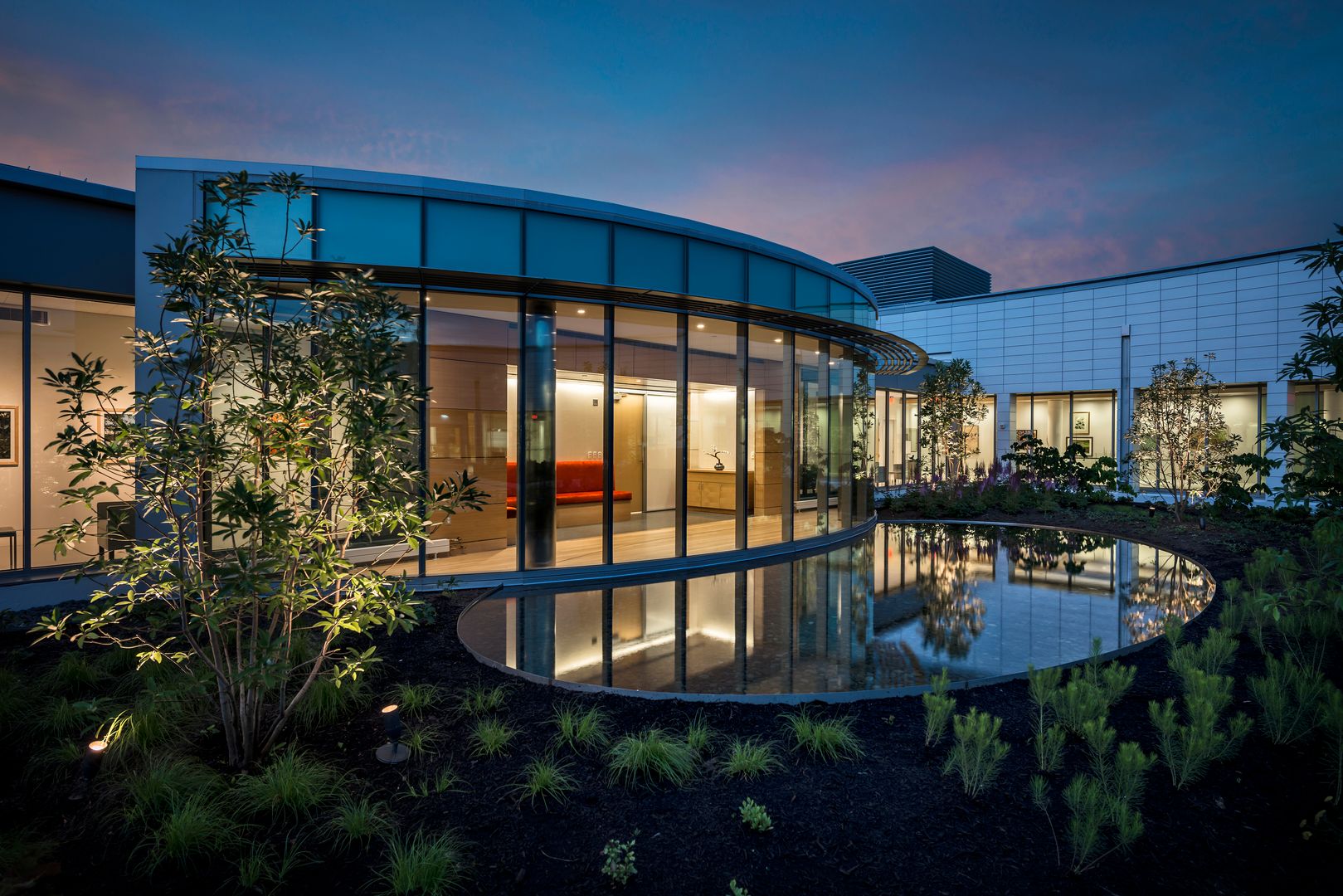 Views from the outside of the building with a pond and landscaping